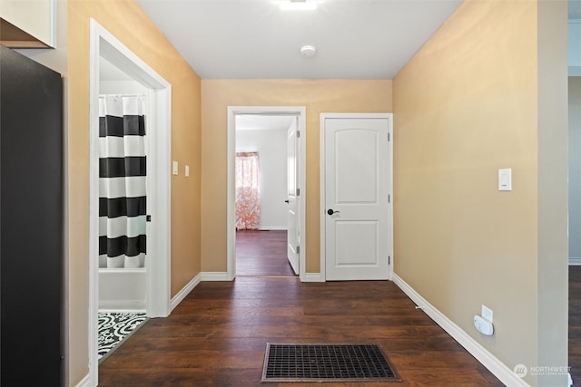 corridor with dark wood-type flooring