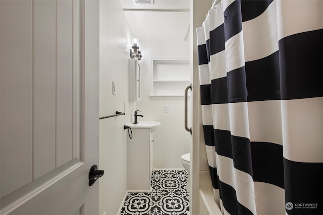 bathroom featuring walk in shower, vanity, and toilet