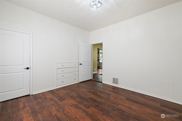 unfurnished bedroom with dark hardwood / wood-style flooring