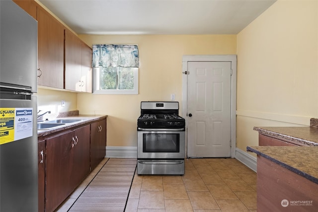 kitchen featuring light tile patterned flooring, sink, and appliances with stainless steel finishes