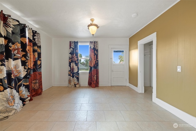 tiled foyer entrance featuring a textured ceiling