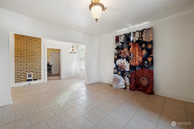 unfurnished room featuring heating unit, light tile patterned floors, and a notable chandelier