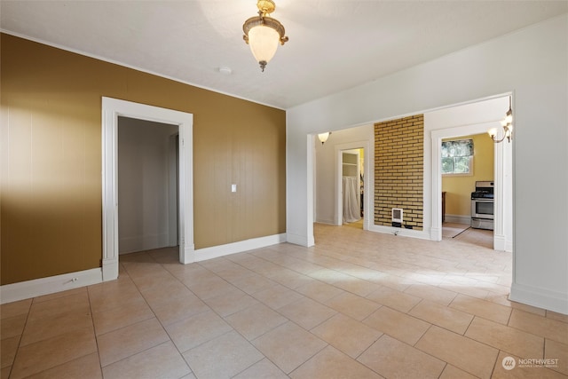 unfurnished room featuring a notable chandelier and light tile patterned flooring