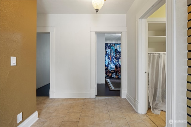 corridor featuring light tile patterned flooring