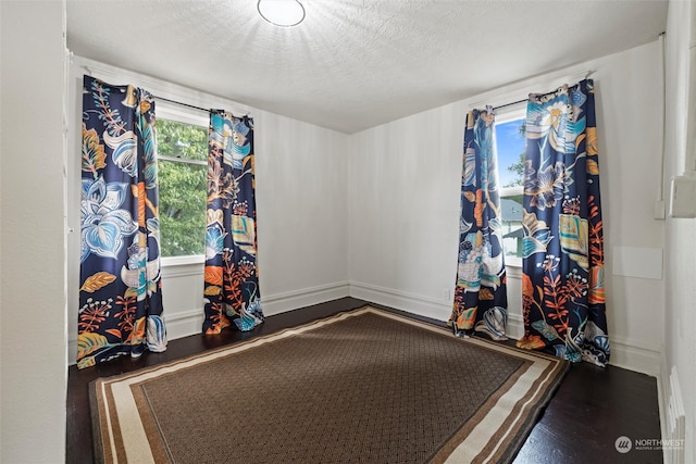 playroom featuring wood-type flooring and a textured ceiling