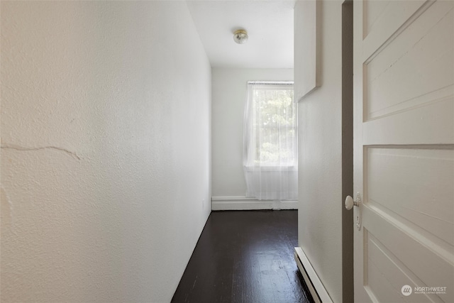 hallway featuring dark hardwood / wood-style flooring and a baseboard radiator