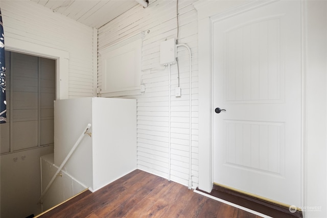 interior space featuring wood walls and dark hardwood / wood-style flooring