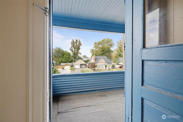 doorway to outside featuring carpet