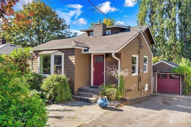 view of front of home featuring an outbuilding and a garage