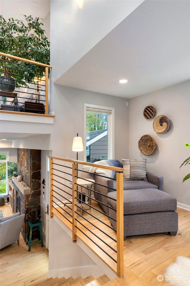 interior space featuring a stone fireplace and wood-type flooring