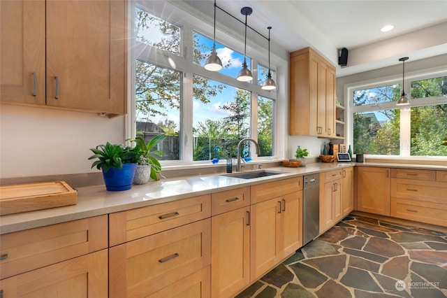 kitchen with pendant lighting, dishwasher, sink, and light brown cabinetry