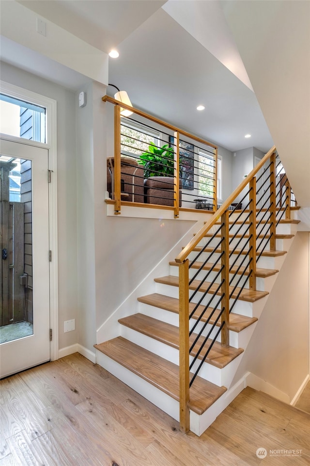 stairway featuring wood-type flooring