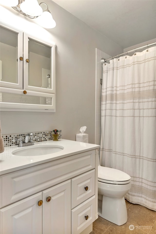 bathroom featuring tile patterned floors, walk in shower, vanity, and toilet