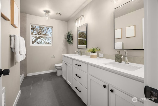 bathroom with tile patterned floors, vanity, and toilet