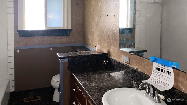 full bathroom featuring vanity, separate shower and tub, and toilet