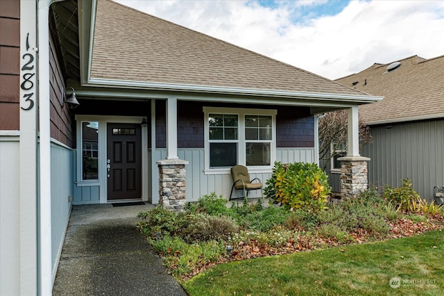 view of exterior entry with covered porch