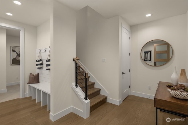 stairway with hardwood / wood-style floors