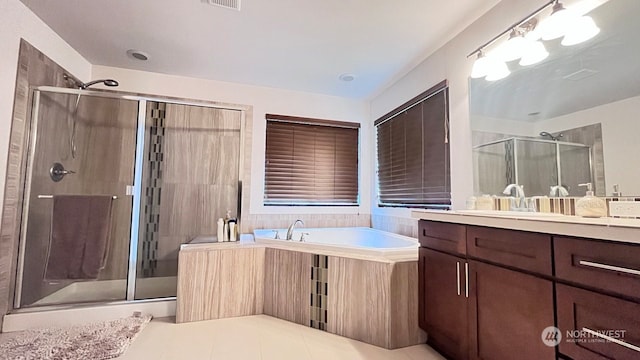 bathroom with tile patterned floors, vanity, and independent shower and bath