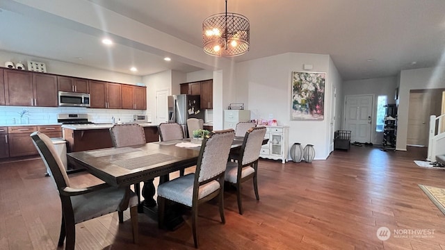 dining room featuring hardwood / wood-style floors and a chandelier