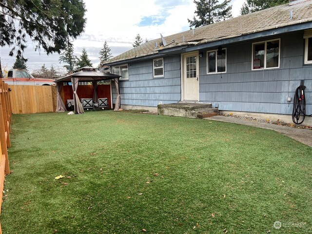 exterior space with a gazebo and a yard