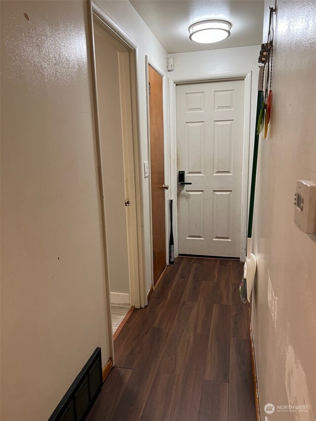 corridor featuring dark hardwood / wood-style floors