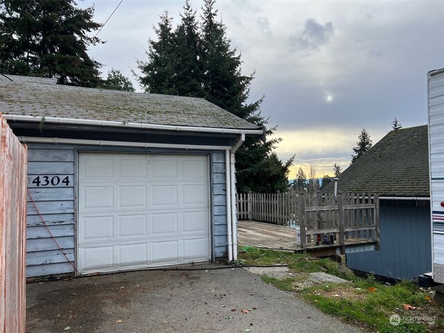 view of garage at dusk