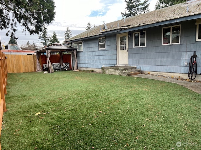 exterior space with a gazebo and a lawn