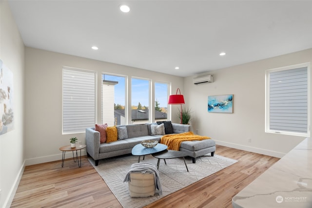 living room featuring light wood-type flooring and an AC wall unit