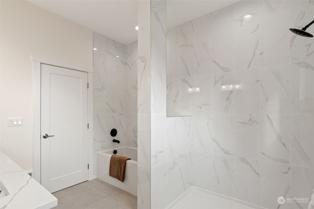 bathroom with tile patterned floors and tiled shower / bath