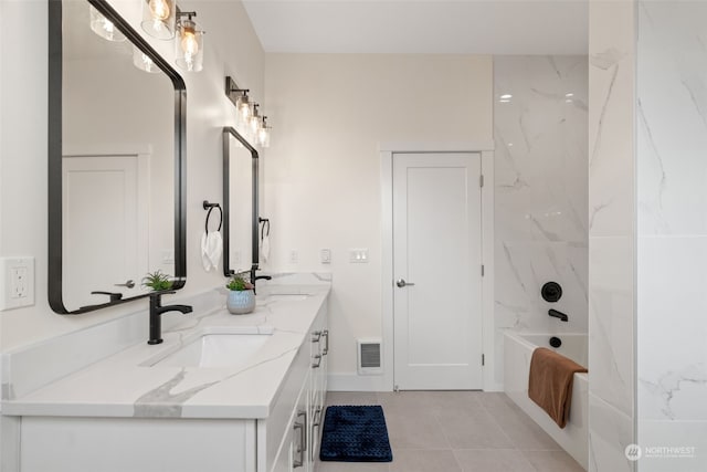 bathroom with tile patterned floors, vanity, and tiled shower / bath