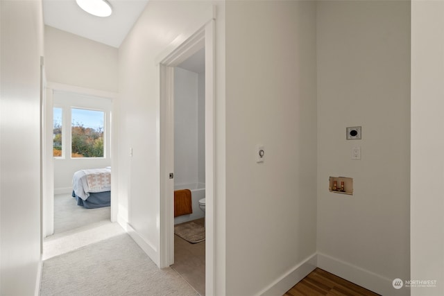 clothes washing area with electric dryer hookup, light carpet, and hookup for a washing machine