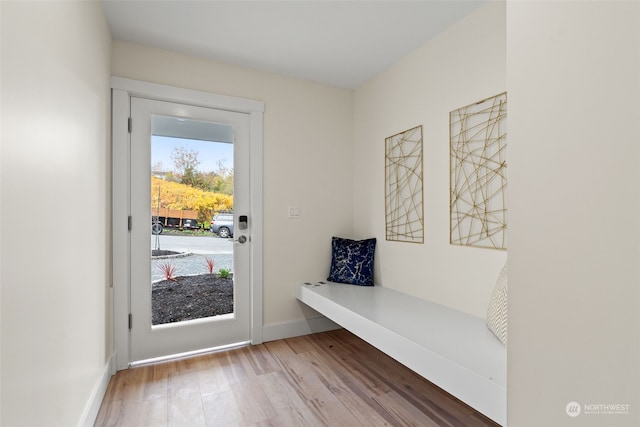 doorway with hardwood / wood-style flooring