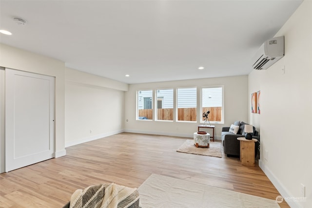 living area featuring a wall mounted AC and light wood-type flooring