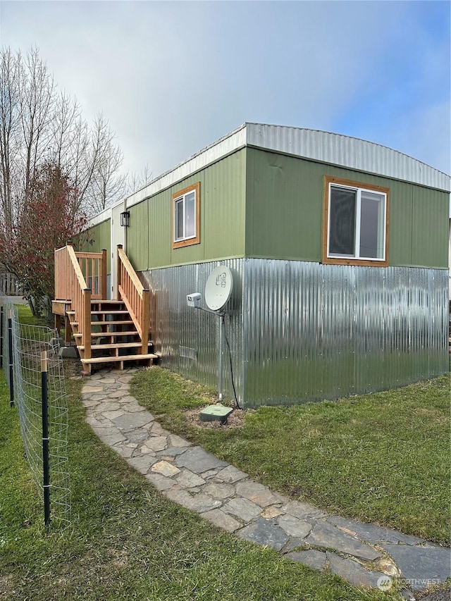 view of side of home with a lawn