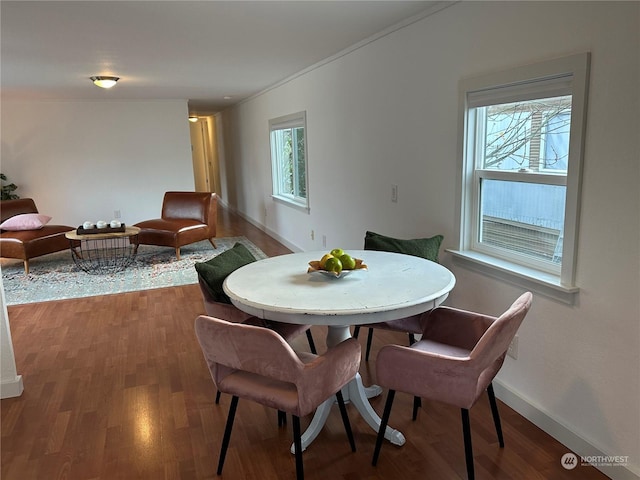 dining area featuring hardwood / wood-style floors and a healthy amount of sunlight