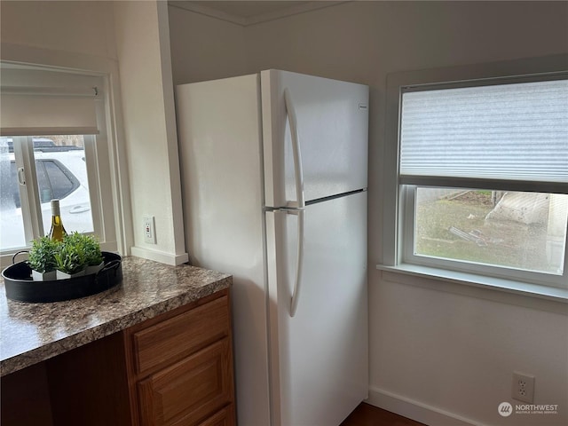 kitchen with white refrigerator and a wealth of natural light