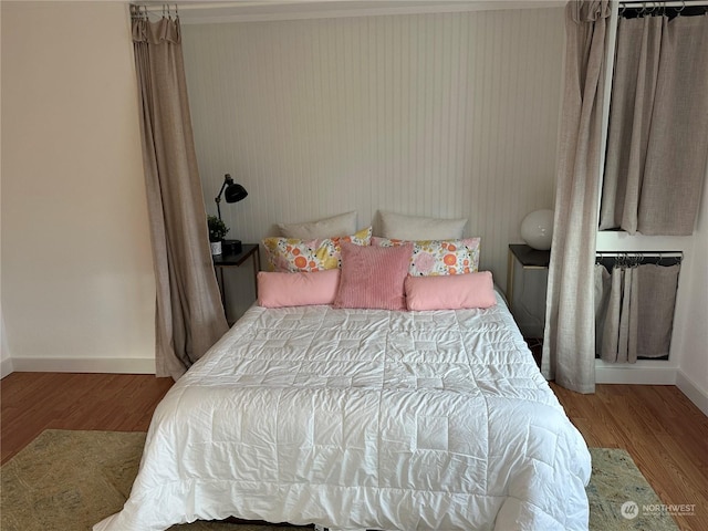 bedroom with hardwood / wood-style flooring and crown molding