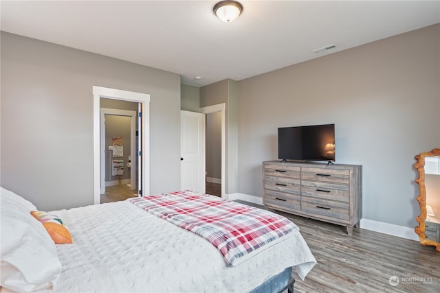 bedroom with dark wood-type flooring