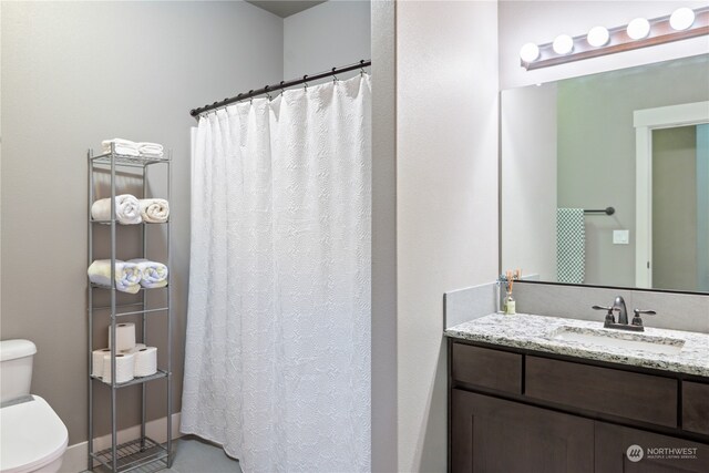 bathroom featuring vanity and toilet