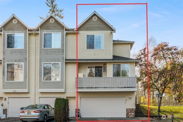 view of property with an attached garage and driveway