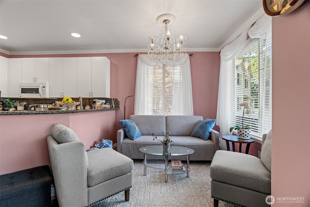 living area with ornamental molding, a chandelier, and recessed lighting