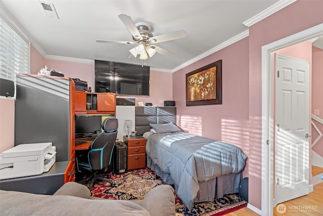 bedroom with a ceiling fan, light wood-type flooring, visible vents, and crown molding