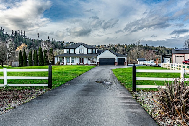 view of front of house featuring a garage and a front lawn