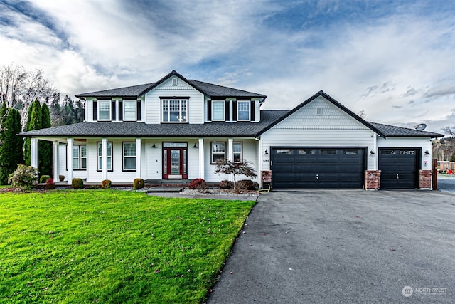 view of front facade featuring covered porch, a garage, and a front lawn