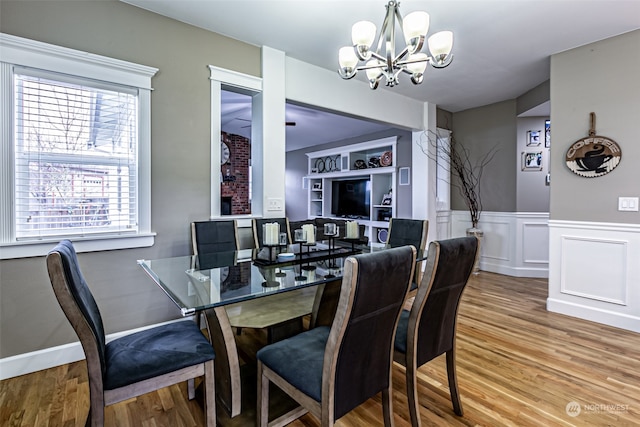 dining space with a chandelier and wood-type flooring