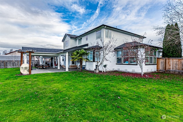 rear view of house featuring a yard and a patio