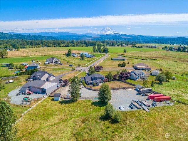 birds eye view of property with a mountain view and a rural view