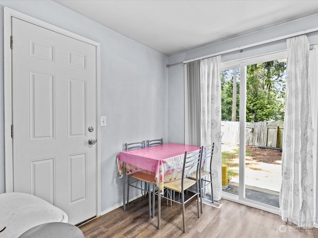 dining space with hardwood / wood-style floors