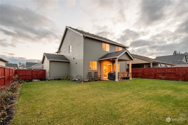 rear view of property with a yard