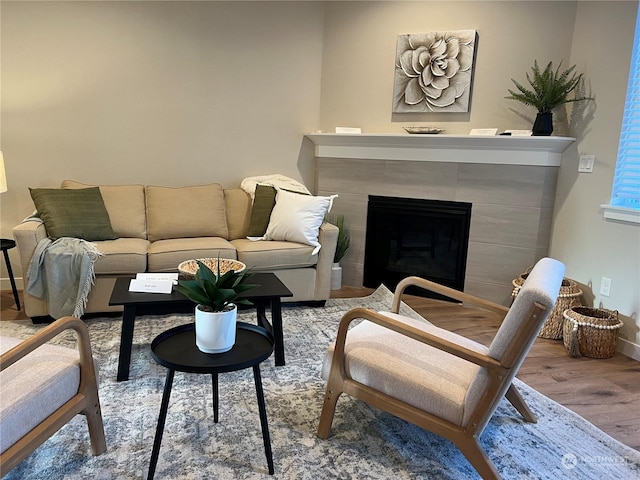 living room with light hardwood / wood-style floors and a tile fireplace